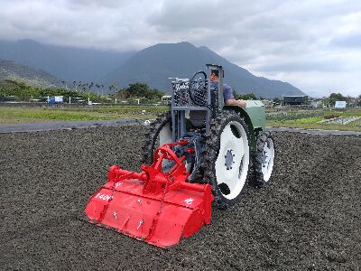 A tractor equipped with a rotary plow for land preparation operations.--view in new window
